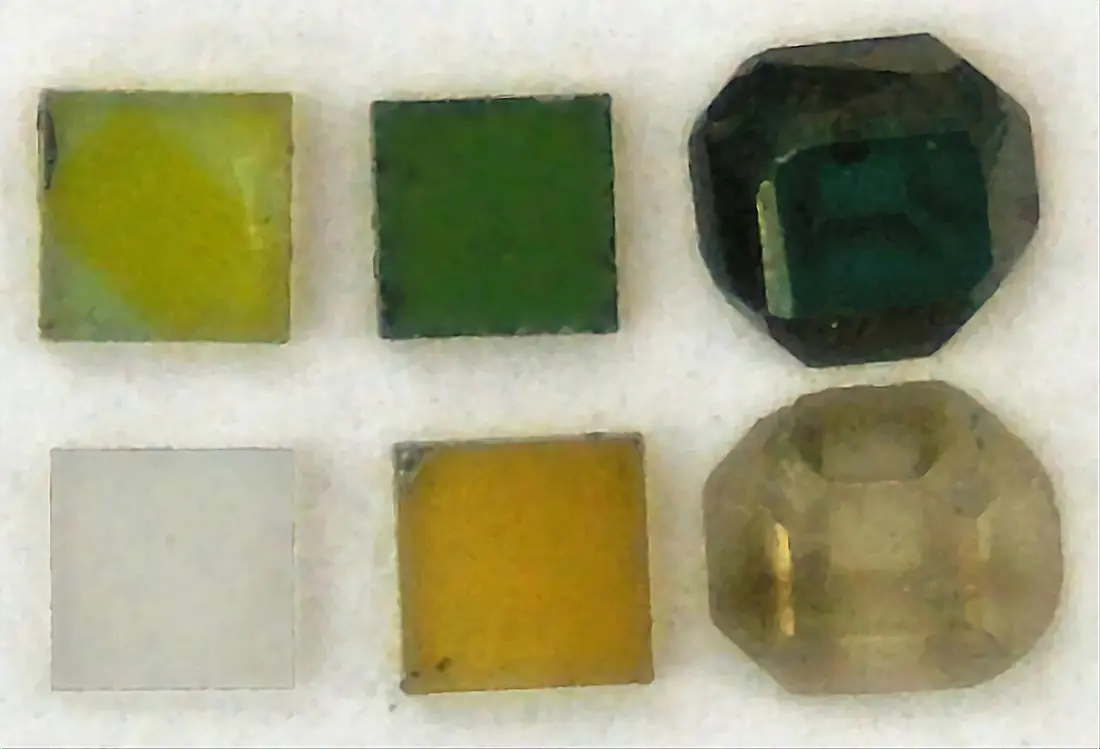 Diamond samples showing colour changes after irradiation and annealing, from colourless to green, yellow and blue-green