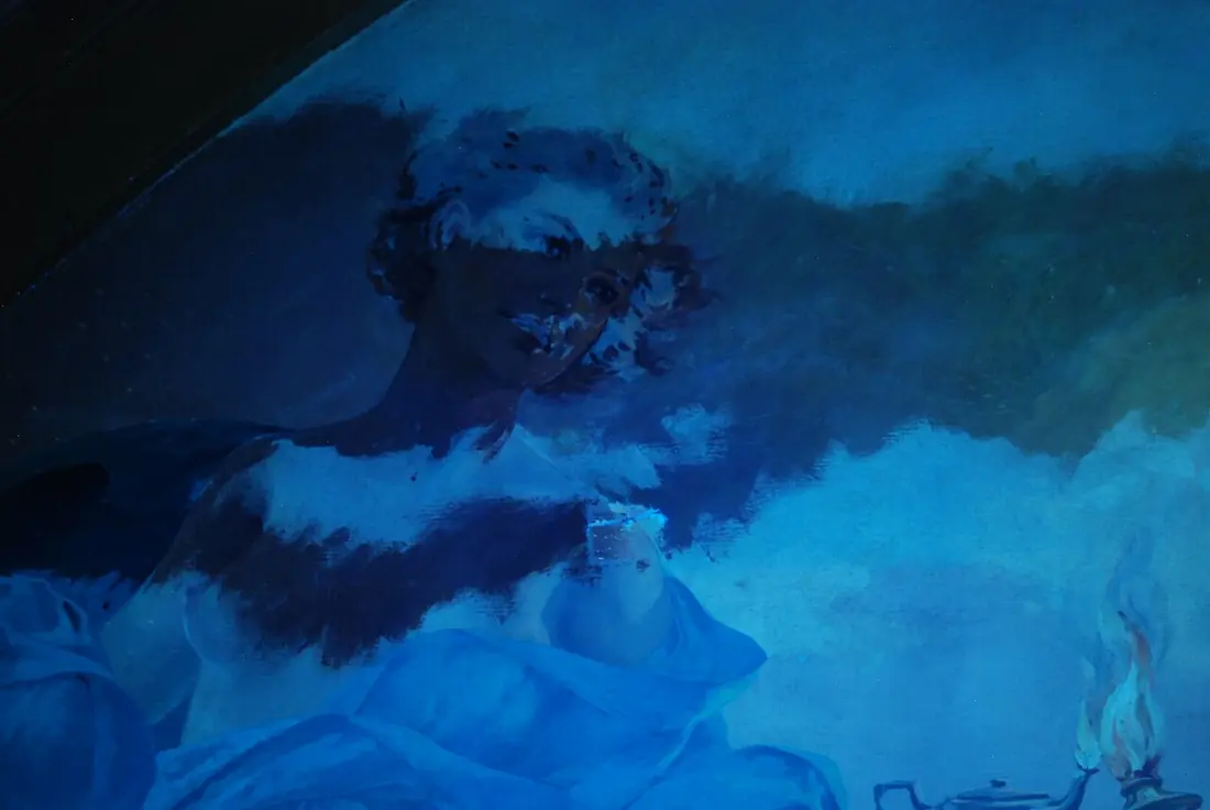 A painted figure photographed under ultraviolet light, with dark patches revealing extensive later retouching